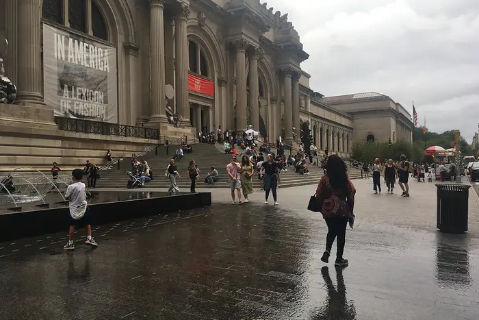 People frolic in front of the Metropolitan Museum of Art.